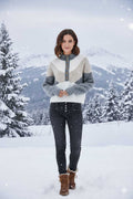 A cozy, color-block sweater featuring a high mock neck and a button-front placket.