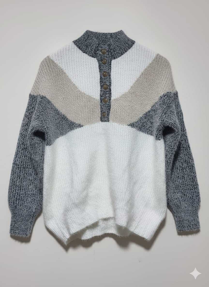A cozy, color-block sweater featuring a high mock neck and a button-front placket.