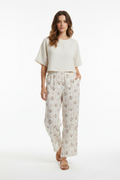 Model wearing seashell print wide-leg pants - studio front shot