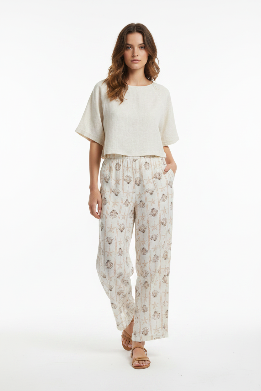 Model wearing seashell print wide-leg pants - studio front shot
